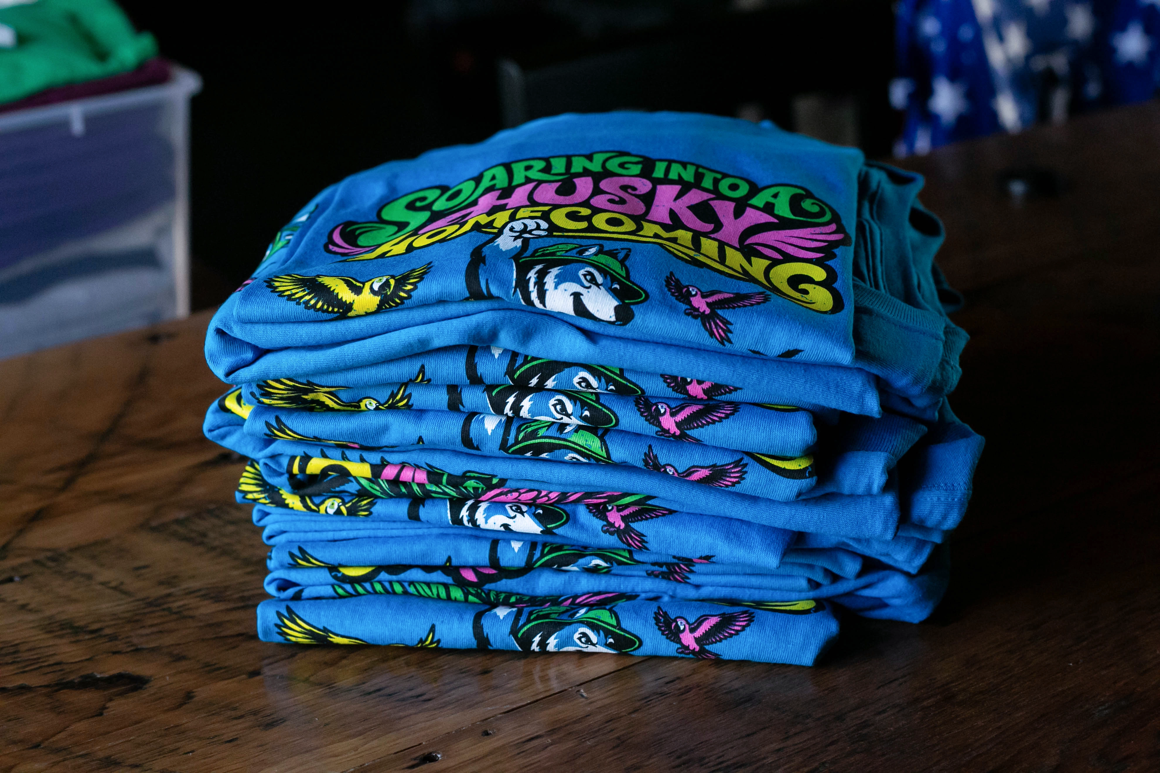 Stack of colorful custom homecoming shirts
